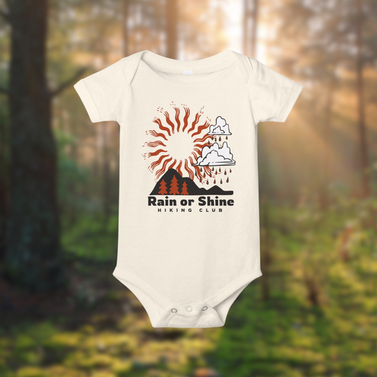 Rain or Shine Hiking Club baby onesie featuring sun and clouds design, ideal for little adventurers. 100% cotton.