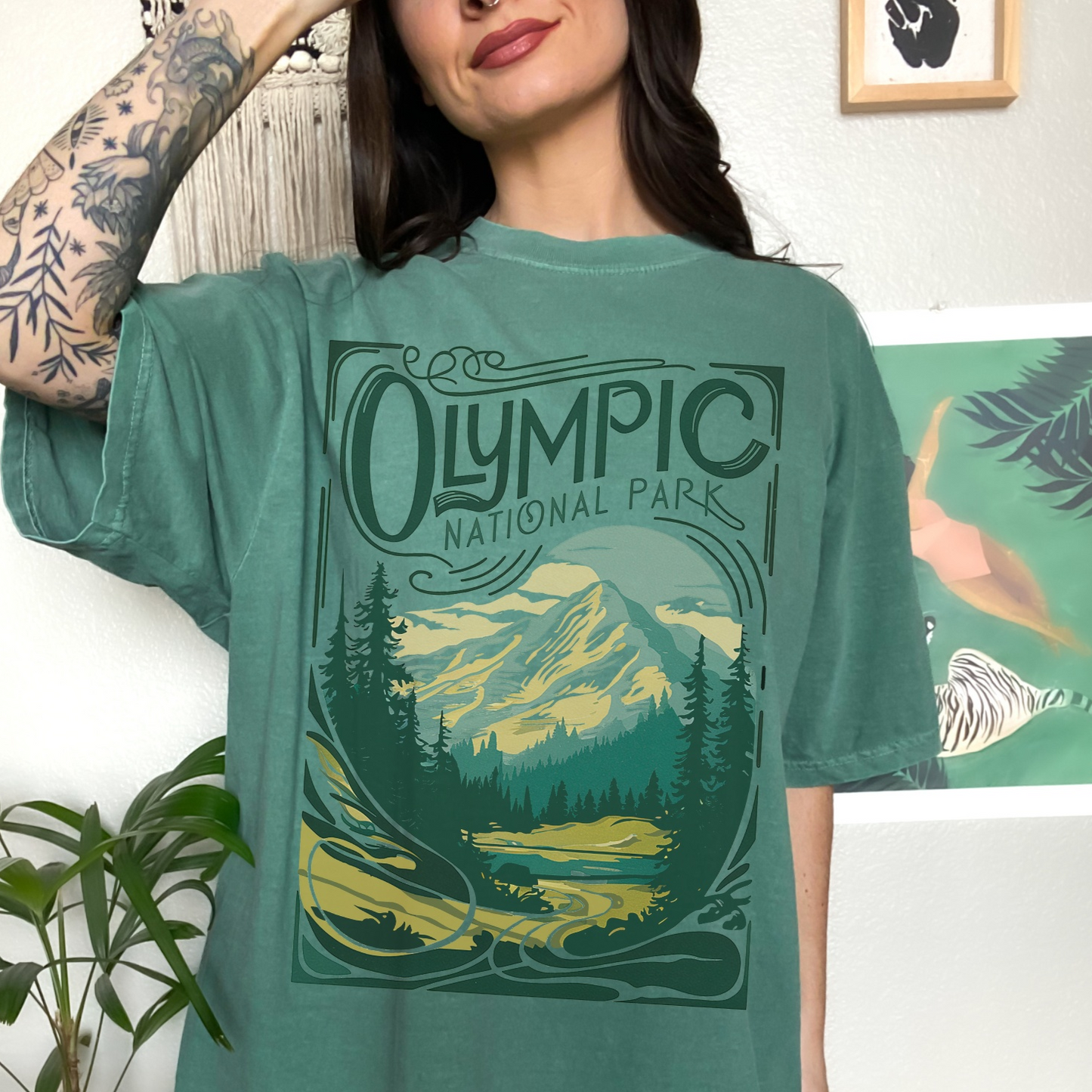 Vintage Olympic National Park 1938 T-shirt featuring a scenic mountain design in lush green and turquoise colors.