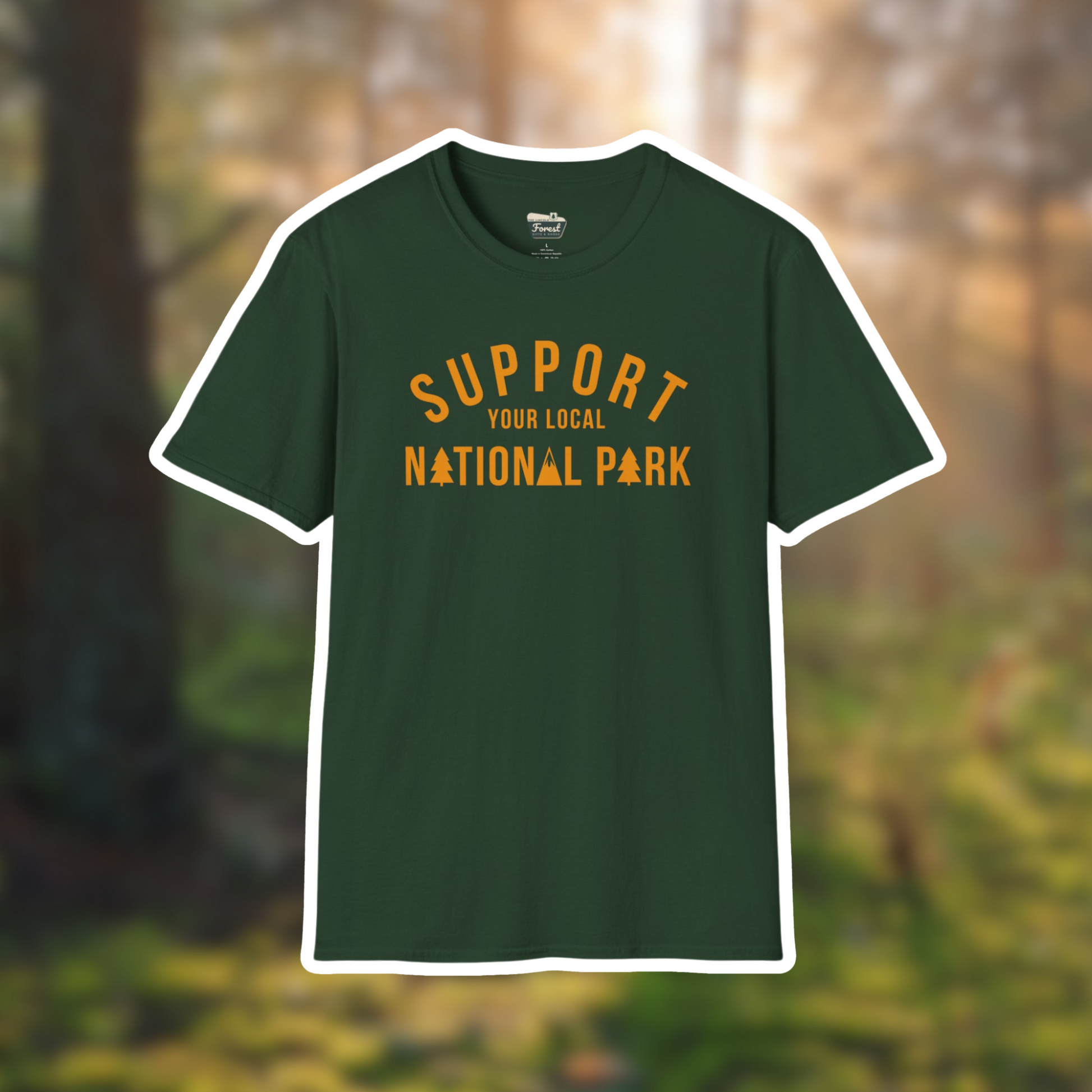 Dark green t-shirt with "Support Your Local National Park" in bold orange letters, set against a nature background.