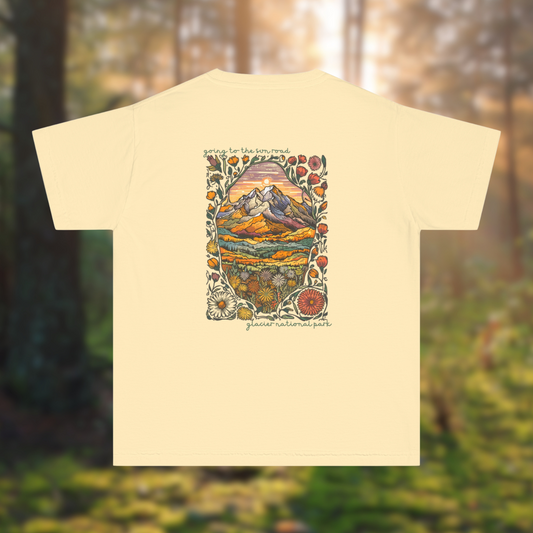 Youth tee featuring colorful mountain sunset and wildflowers, inspired by Glacier National Park.