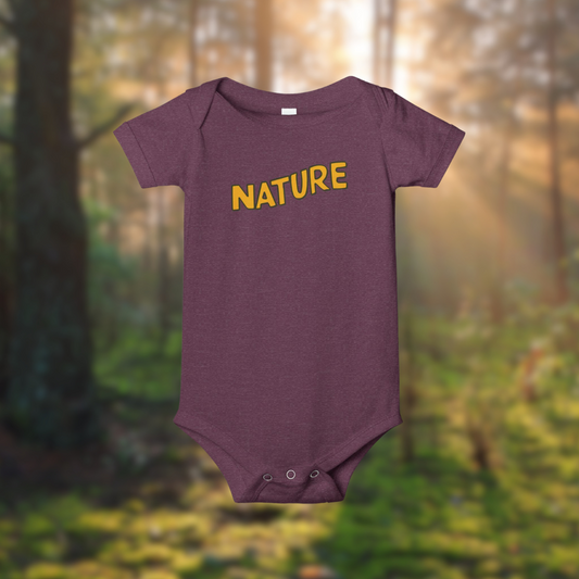Nature Baby Onesie in purple with bold 'NATURE' text, set against a forest background, made of 100% cotton.