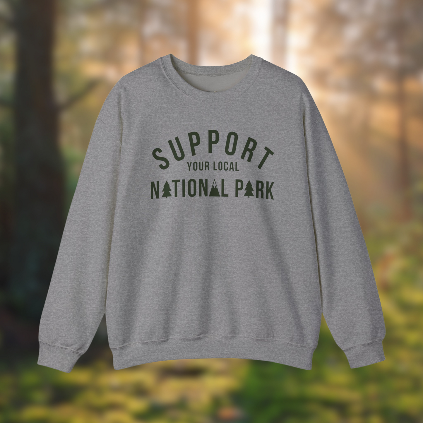 Support Your Local National Park gray sweatshirt displayed in a forest setting, showcasing cozy design and eco-friendly message.