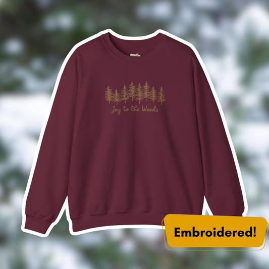 Joy to the Woods maroon embroidered crewneck featuring pine trees, perfect for cozy holiday outfits.