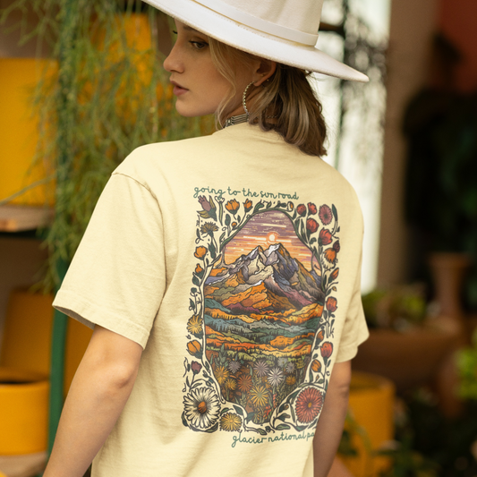 Going to the Sun Road T-shirt featuring vibrant Glacier National Park mountain scene and floral design on back.