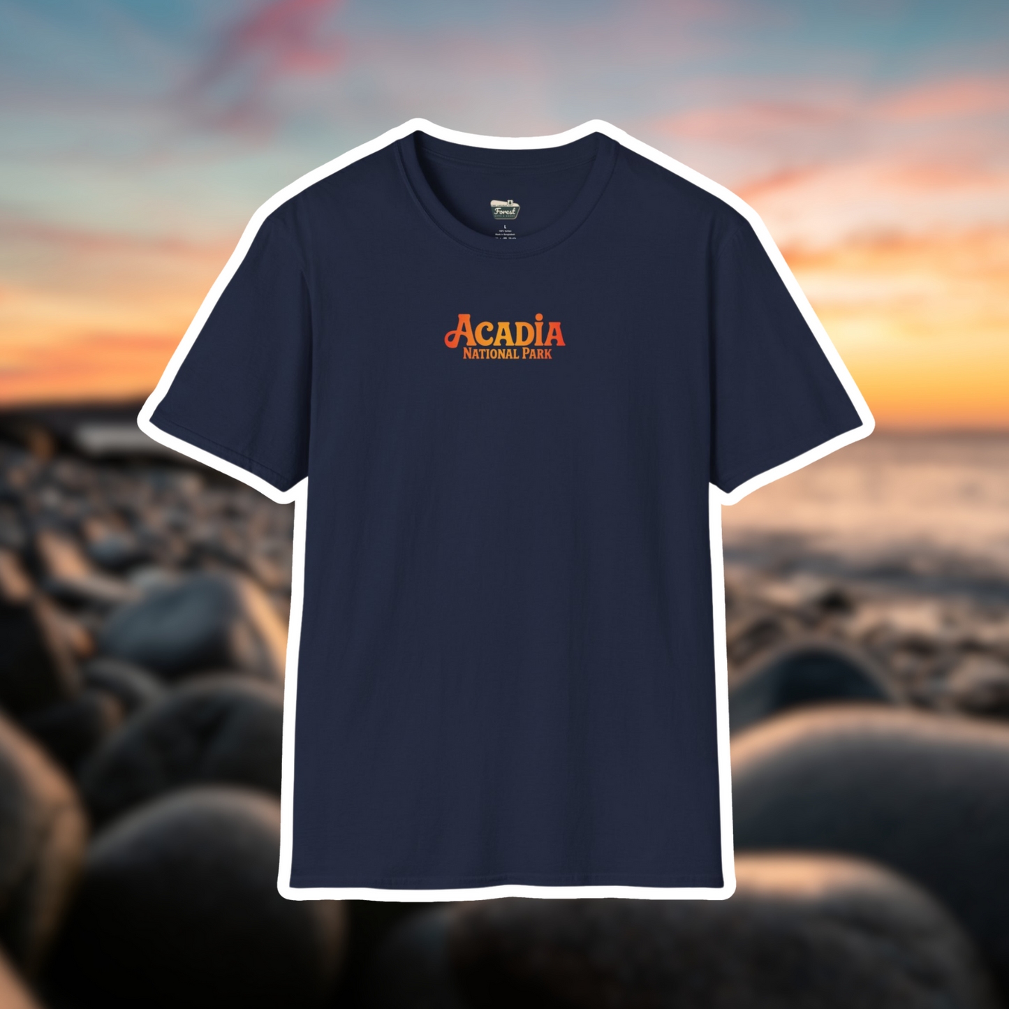 Navy blue Acadia National Park shirt featuring hand-drawn sunrise design against a scenic sunset background.
