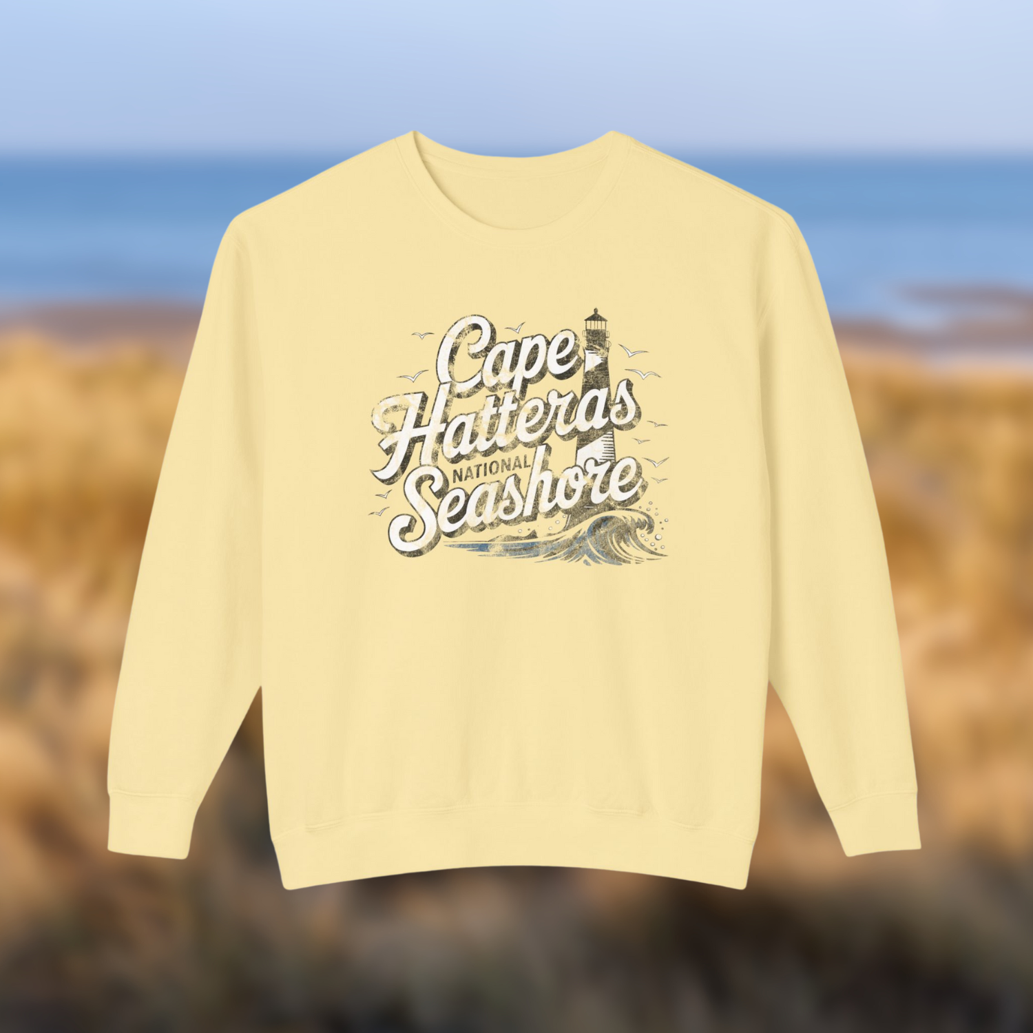 Vintage-style yellow crewneck sweatshirt featuring Cape Hatteras National Seashore lighthouse design.