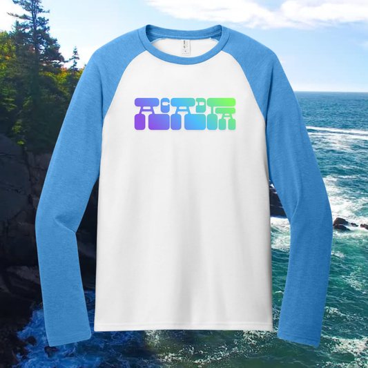 Acadia Heritage Raglan Tee with blue sleeves and colorful retro graphic, set against a coastal background.