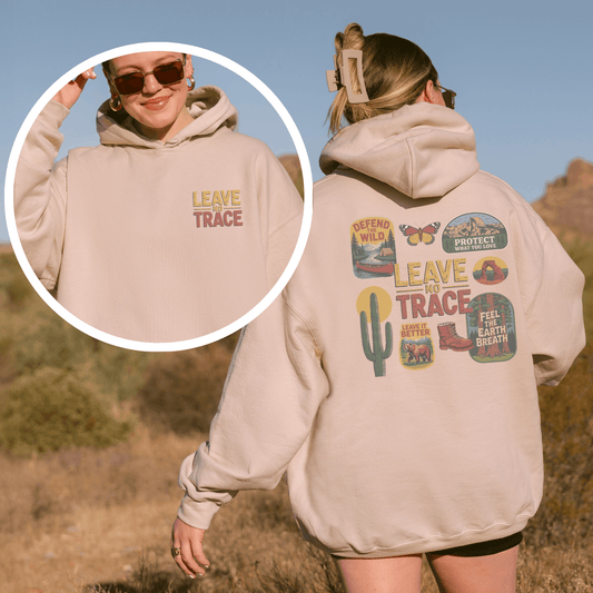 Woman wearing a beige Leave No Trace Hoodie featuring vintage patches and graphics celebrating outdoor stewardship.