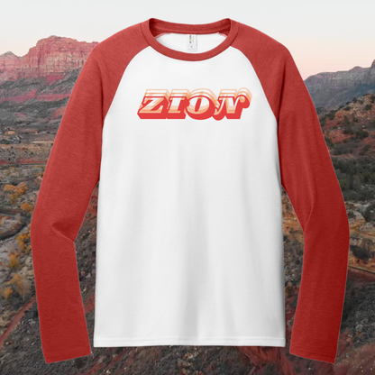 Zion Heritage Raglan Tee featuring retro design and canyon-red sleeves against scenic background.