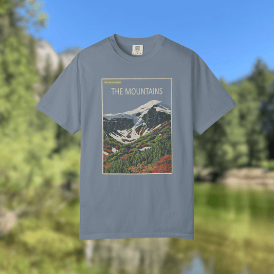 The Mountains Tee - Nature Library Series featuring a vintage alpine graphic on a blue shirt.