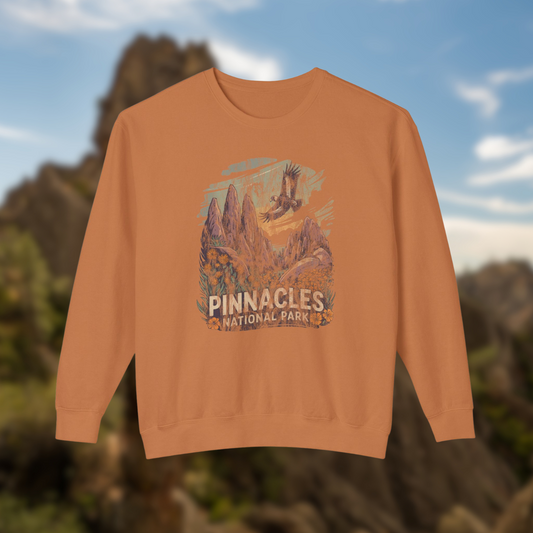 Pinnacles National Park Crewneck Sweatshirt featuring dramatic cliffs and condor designs on a cozy orange fleece.
