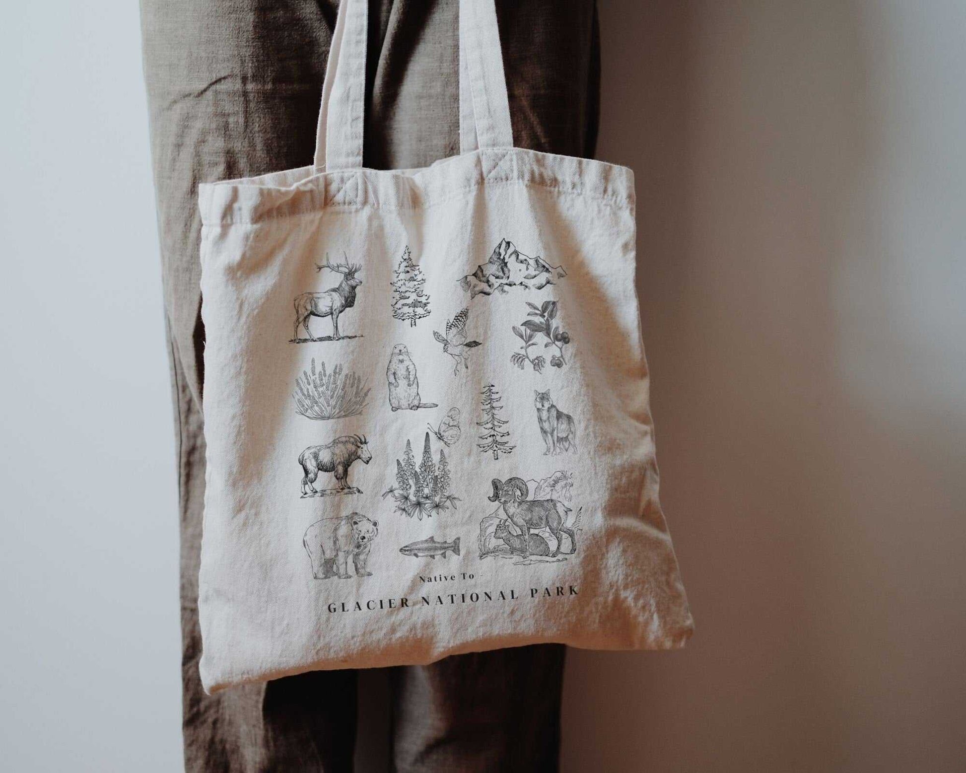 Glacier National Park ToteThese organic cotton tote bags feature the iconic flora and fauna of Glacier National Park in the state of Montana.
Details:
- 15.75"h x 15.25"w - handle length of 2