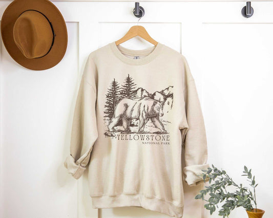 Yellowstone National Park Grizzly SweatshirtBring the beauty of Yellowstone National Park in Wyoming into your wardrobe with this vintage styled boyfriend crewneck sweatshirt inspired by the king of this iconi