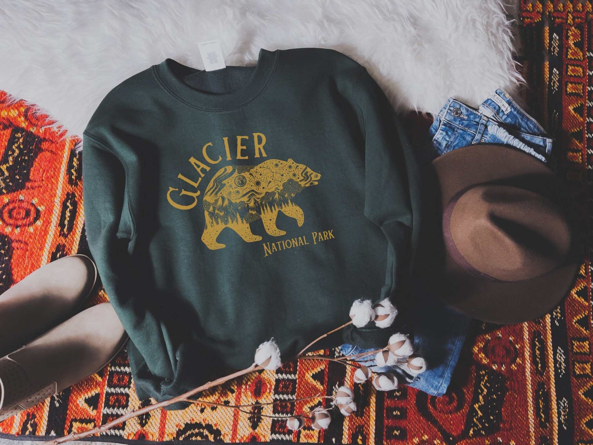 Glacier National Park Galaxy Bear SweatshirtBring the magic and beauty of Glacier National Park at night into your sweater rotation with this crewneck galaxy grizzly bear sweatshirt inspired by the midnight ma