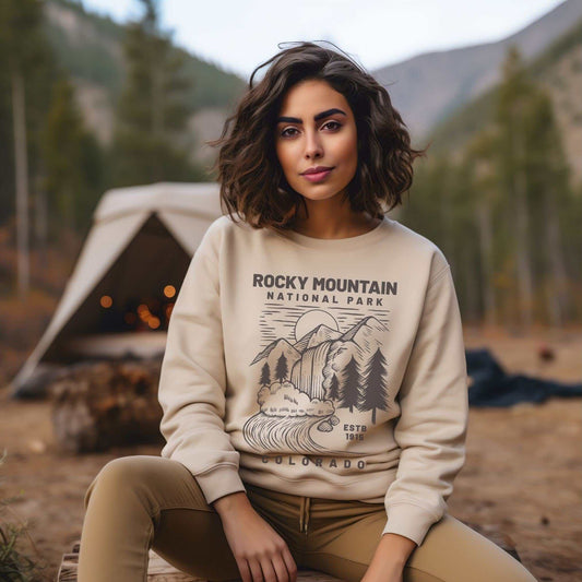 Rocky Mountain National Park SweatshirtBring the beauty of Rocky Mountain National Park of Colorado into your wardrobe with this simple waterfall and mountain landscape cozy and comfy crewneck sweatshirt 